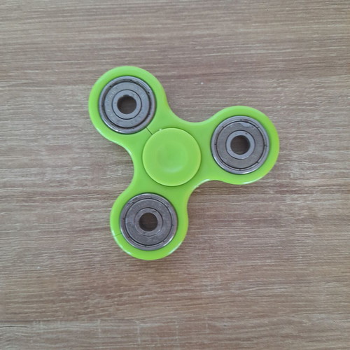 Fidget spinner used, metal with wear