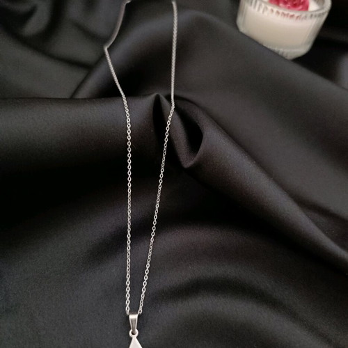 Minimal handmade steel chain necklace with a triangle pendant featuring a carved eye