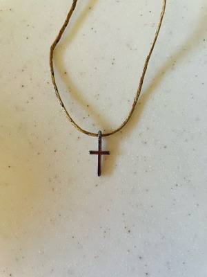 Small metal cross on adjustable cord, like new, silver color