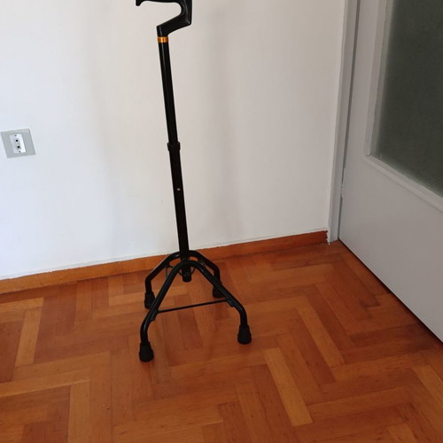 Walking cane with four-legged base used, adjustable height