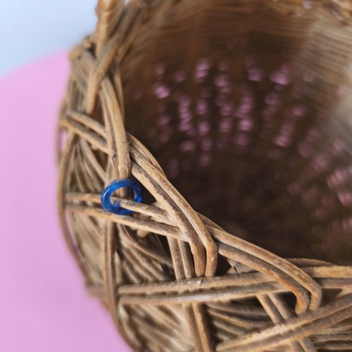Handmade woven basket used with handle and decorative beads