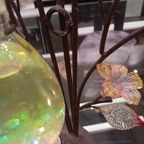 Decorative candle holder with metal tree base, used