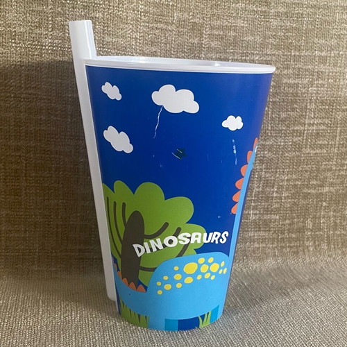 Plastic cup with dinosaur design and straw used