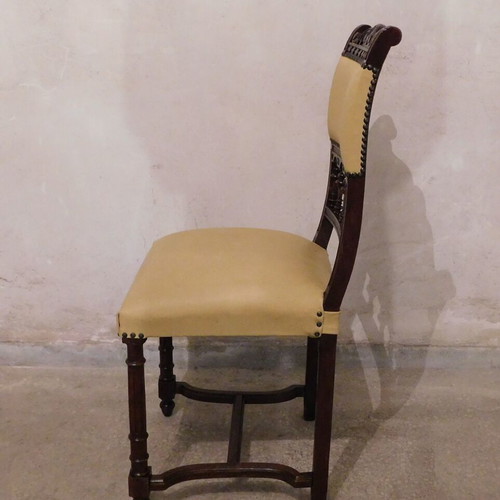 Wood-carved chair with leather seat like new, about 100 years old