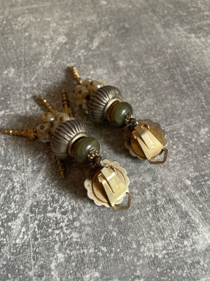 Gold dangling earrings used, missing some dangles
