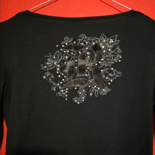 Black top with prints and rhinestones like new