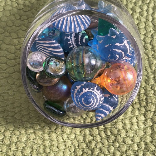 Glass decorative piece with blue sea-themed marbles and stones