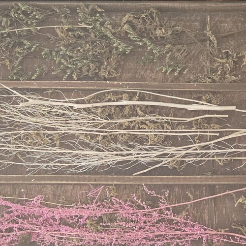 Wooden decorative serving tray used with dried flowers and glass surface