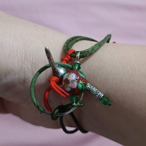 Bracelet new with various charms on green cord