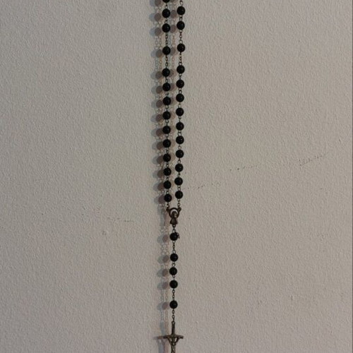 Traditional rosary used, black beads and silver elements