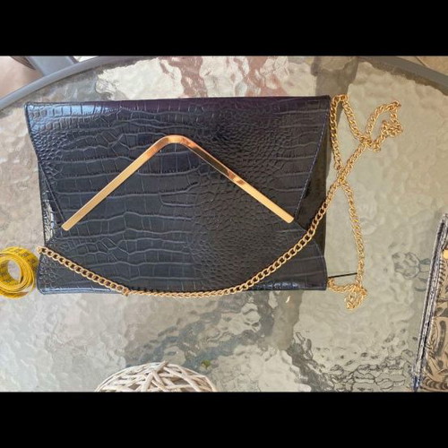 Blue clutch bag used with gold detail