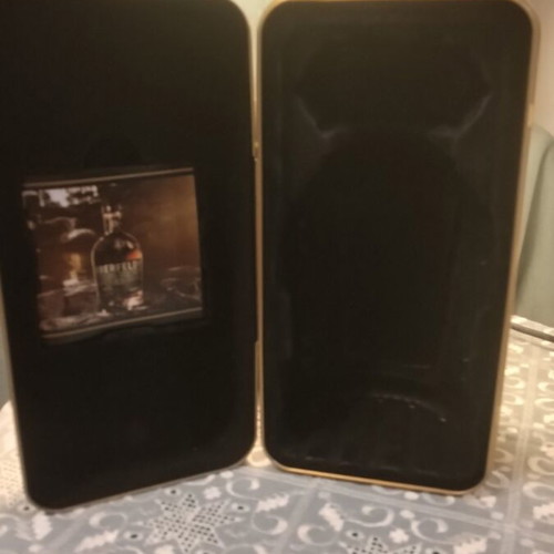 Metal Bottle Case like new with collectible bottle