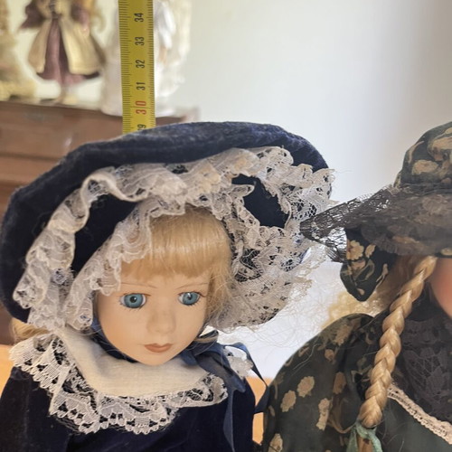 Pair of porcelain dolls with hats, 30 cm