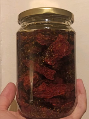 Jar of sun-dried tomatoes new with olive oil and oregano
