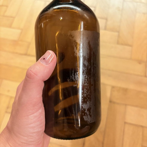 Brown glass pharmacy-style bottle with cap