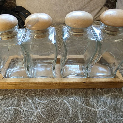 Set of 4 glass jars with wooden lids and wooden base like new