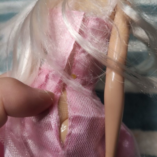 Barbie doll used with dress tears