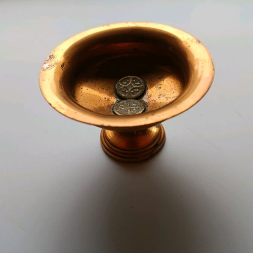 Copper decoration with two old coins used