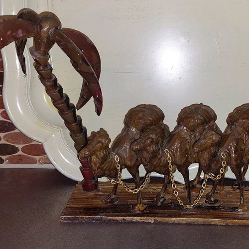 Decorative item used with camels and palm tree made of wood and plastic
