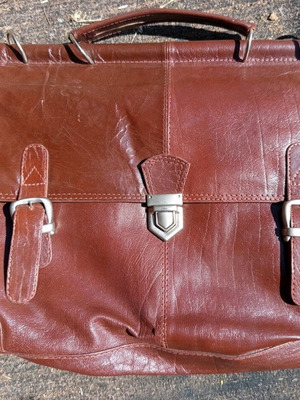 Bag used with central button clasp and rings for strap