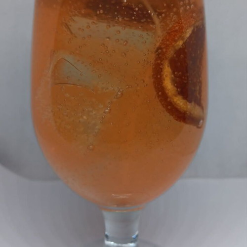 Handmade candle in Aperol Spritz glass with Aperol Spritz scent