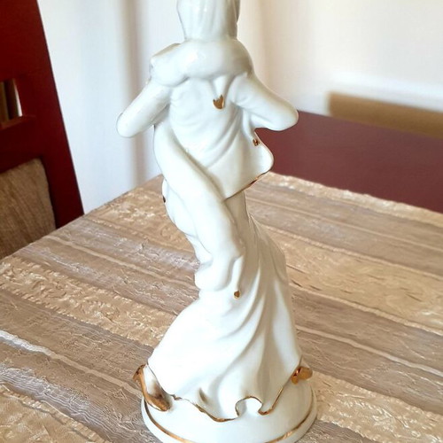 Porcelain figure of a woman with gold details, like new