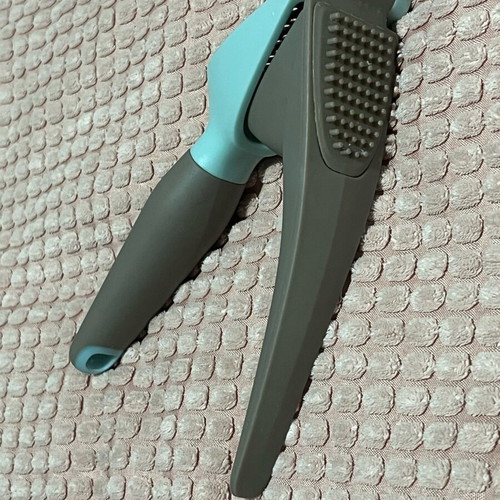 Garlic press used with ergonomic handle and easy cleaning