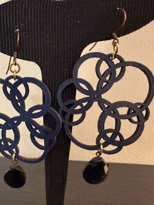 Earrings with blue laser cut leather flower design like new