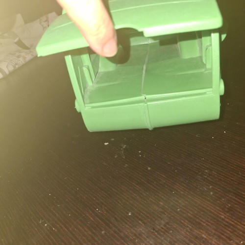 Green toy truck with opening feature