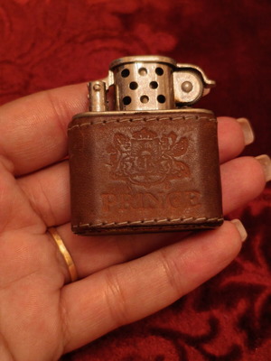 Vintage Prince petrol lighter used with leather cover