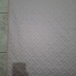 Quilted bed cover in soft pink