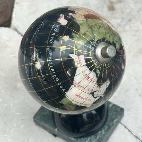 Decorative globe made of semi-precious stones with clock and marble base used
