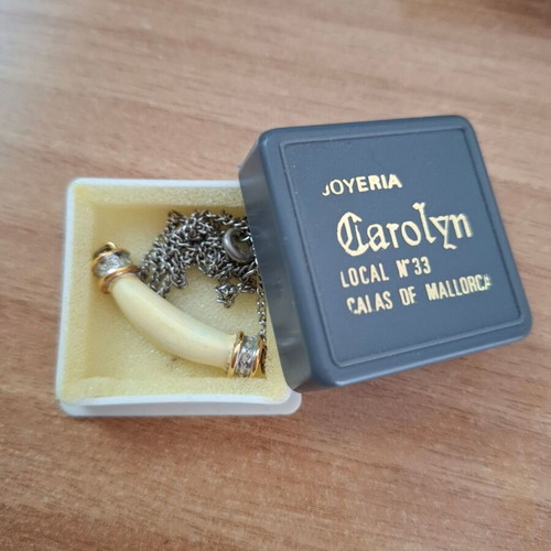 Necklace with ivory tusk pendant used, gold caps and strass decoration