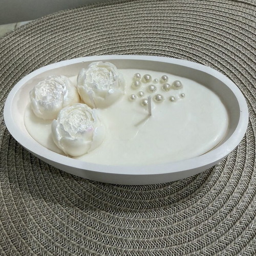 Handmade aromatic candle with flowers in oval container