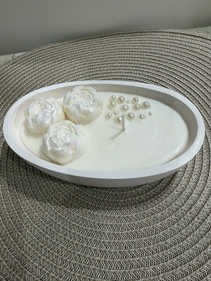 Handmade aromatic candle with flowers in oval container