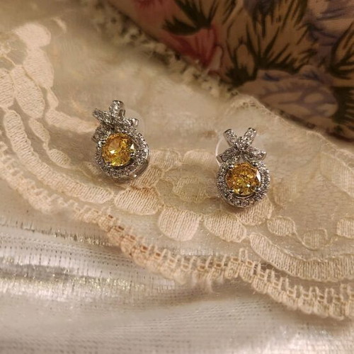 Steel earrings new with yellow stone and small diamonds