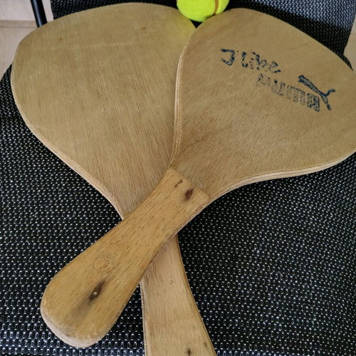 Wooden beach rackets used with new ball