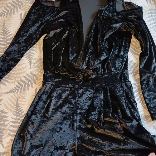 Black velvet jumpsuit like new with deep neckline and off-shoulder design