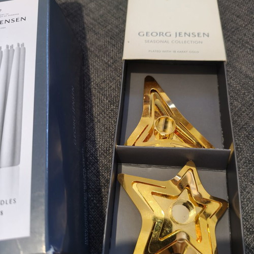 Georg Jensen gold-plated star candle holders with candles