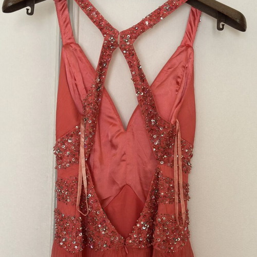 Coral short evening dress with crisscross straps, V neckline, and shiny embroidered beads