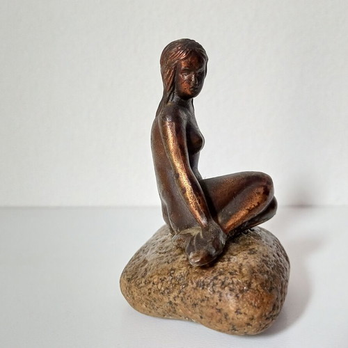 Vintage bronze Little Mermaid statue on natural stone used