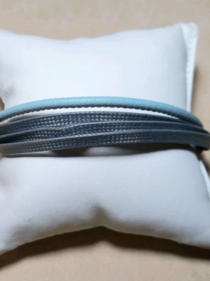 Steel bracelet new with grey and blue cords