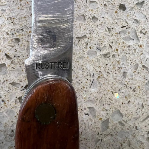 Folding knife used from 1980s with sheath