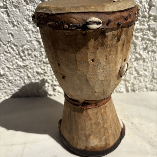 Handmade wooden drum used, African style with leather membrane and shells