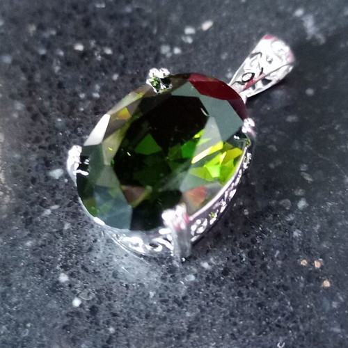 Pendant with green lab topaz in silver-plated base like new