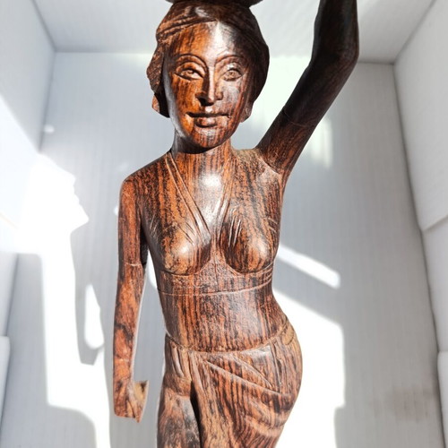 Rosewood figure of woman with basket from Bali, like new