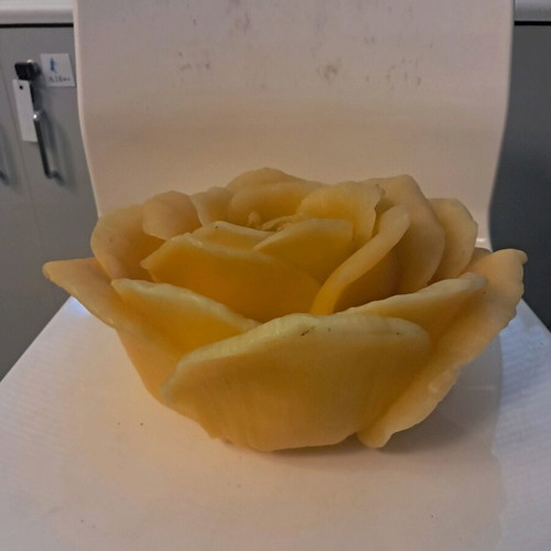 Large decorative rose candle used, yellow