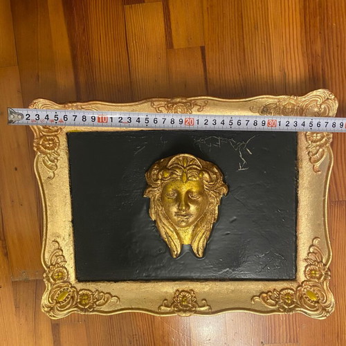 Gold-colored relief head wall art with black background, new