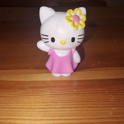 Hello Kitty figure used with pink dress and yellow flower