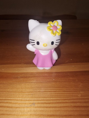 Hello Kitty figure used with pink dress and yellow flower